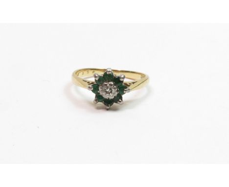 A diamond and emerald cluster ring, stamped ‘18ct’, finger size M, 3 g gross                                                 