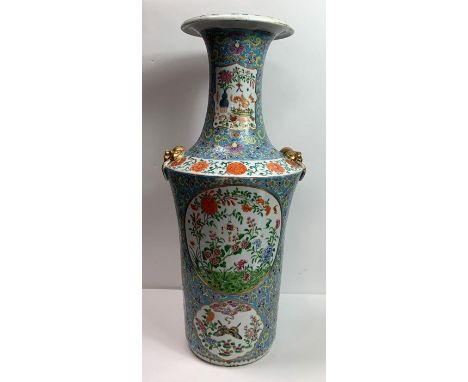 A large Chinese vase with tall neck, moulded gilt painted lion mask ring handles and painted with panels of flowers and symbo