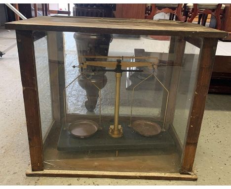 A set of laboratory scales in glass case