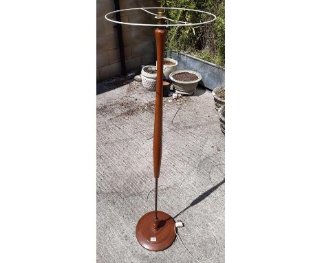A mid century teak and brass standard lamp on stepped circular base, 139cms high