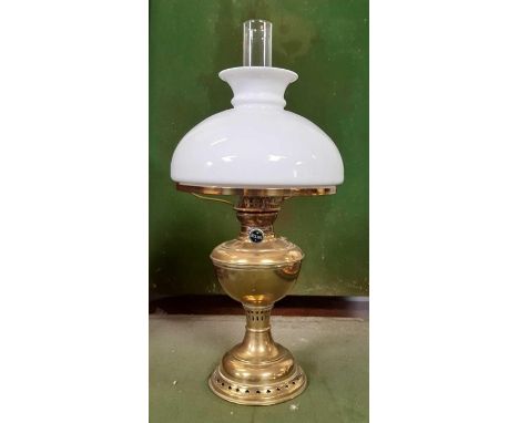 An Edwardian brass oil lamp with white glass shade, Helios burner and with pierced pedestal and base, height to top of shade 