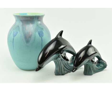 A 20th century Poole Pottery ceramic vase and a pair of graduating Dolphins. The vase of ovid form having lipped rim with pow
