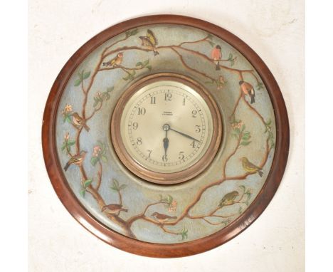 An early to mid 20th century mahogany cased wall clock. The clock having a circular silvered dial marked for Barkers Kensingt
