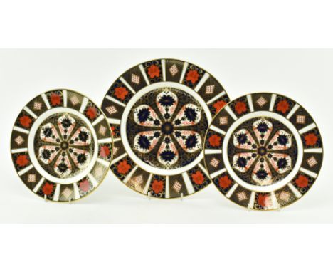 Royal Crown Derby - a collection of three vintage bone china Old Imari plates in the 1128 pattern. Each with highly decorativ