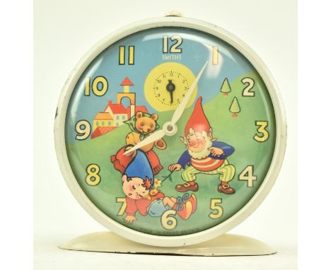 A vintage mid century circa 1950s Noddy clock by Smiths. The clock circular with white enamel body, featuring Toyland, Noddy,