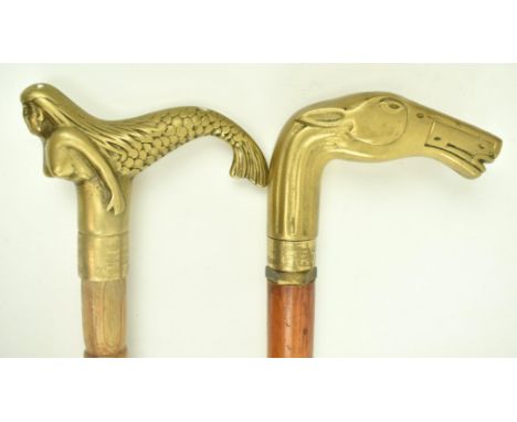 Two vintage mid century animal brass topped wooden walking sticks. Comprising a brass handle in the form of a nude mermaid wi