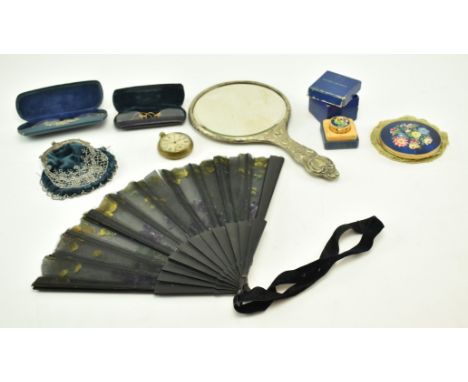 A group of eight early 20th century vanity items. The lot comprising an Art Nouveau mirror, a beaded hand purse, a fan, a Est