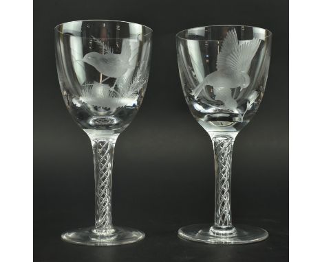 Robert Ellison - a pair of vintage mid century engraved glass wine glasses, each with double air twist stem. Each glass featu