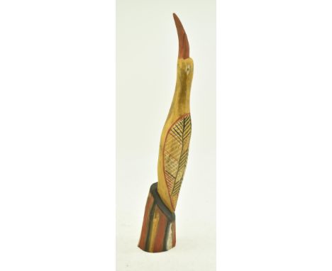 A vintage polychrome carved hardwood bird by Thomas Munkanome of Bathurst Island, Tiwi. The bird standing vertically, hard pa