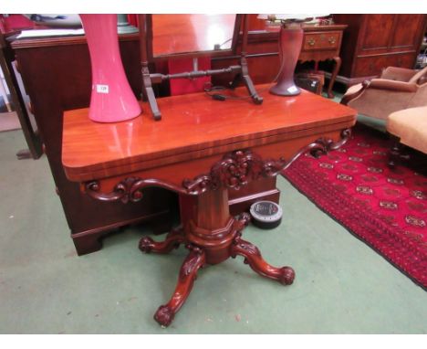 A William IV flame mahogany card table, the fold-over swivel top (with shrinkage crack) over carved acanthus leaf frieze on a