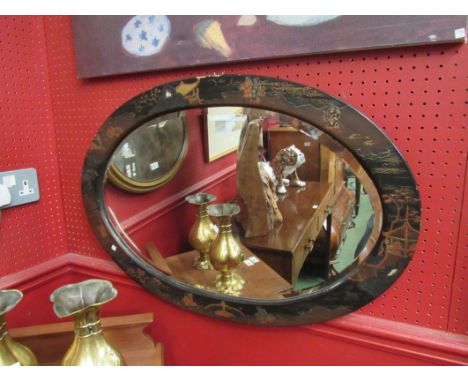 A Chinese oval bevelled edge mirror, with lacquered decoration (c. 1890), 51cm x 74cm including frame