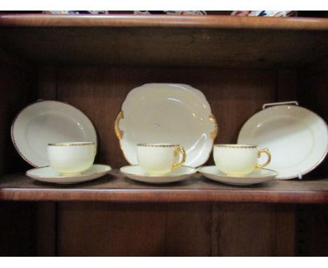 Three Grosvenor tea cups and saucers, cream ground with gilt edge and five Imari style tea plates