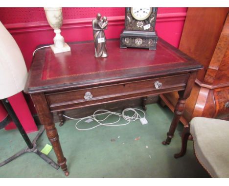 A mid Victorian oak writing desk the tooled leather inset over a single frieze drawer with key on turned and tapering legs wi