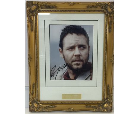 RUSSELL CROWE SIGNED - A 8x10 signed photo of Russell Crowe on set during Gladiator filming. Framed and with plaque below to 
