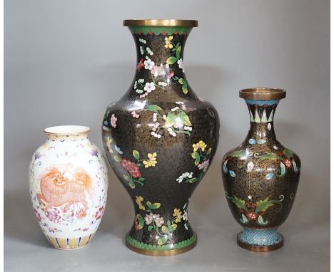 Two Chinese cloisonné enamel vases, and a porcelain ‘lion dog’ vase, tallest 33cm