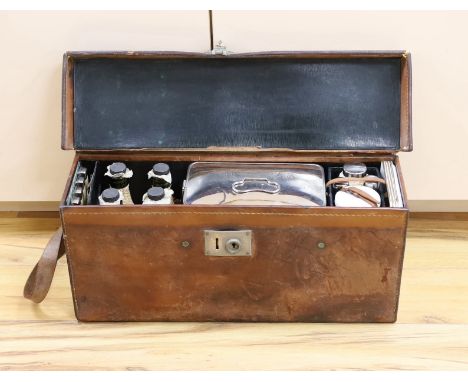 Automobilia related - an early leather cased car picnic hamper, with enamelled plates, basket work covered glass bottles and 