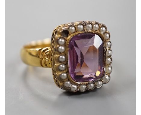 A Victorian 18ct gold, amethyst paste and simulated split pearl cluster set dress ring, size M, gross weight 4.5 grams.