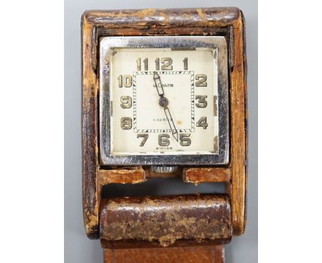A mid 20th century leather case mounted stainless steel LeCoultre for Cartier travelling watch, with Arabic dial, 5cm.