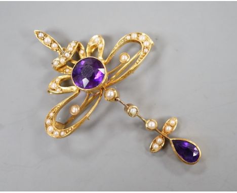 An Edwardian 15ct, amethyst and seed pearl set drop pendant brooch, overall 49mm, gross weight 5.3 grams.