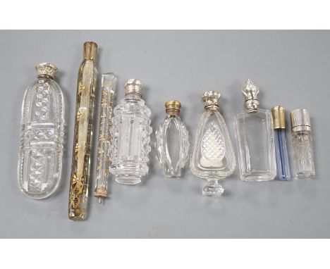Nine assorted late 19th/early 20th century white or gilt white metal mounted glass scent bottles, including Austro-Hungarian 