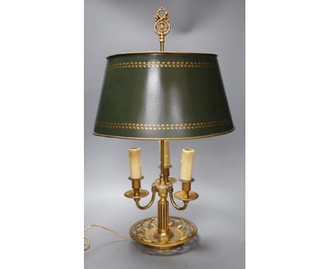 A gilt brass bouillote lamp with tole ware shade,57 cms high,