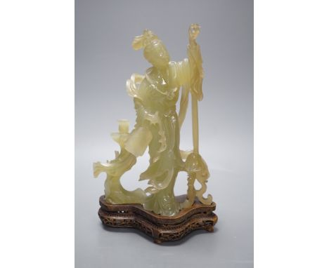 A Chinese carved bowenite jade figure of a lady on a hardwood stand 27cm