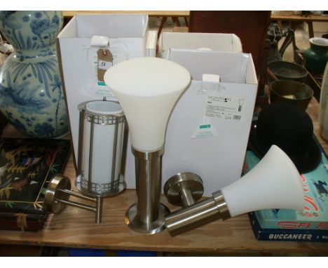 A pair of stainless steel outdoor wall mounted light fittings , boxed. ( 340 ) and two boxed outdoor stainless steel lights w