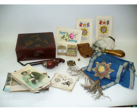 An Antique copper and brass mounted powder flask, a Masonic sash, a Queen Victoria 1897 commemorative cross, Players cigarett