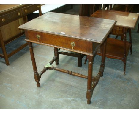 A Continental oak side table with a single drawer and ring turned supports.