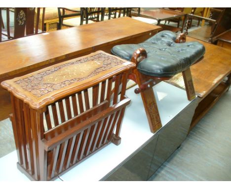An Eastern hardwood and brass inlaid camel saddle stool and a brass inlaid hardwood magazine rack. (2)