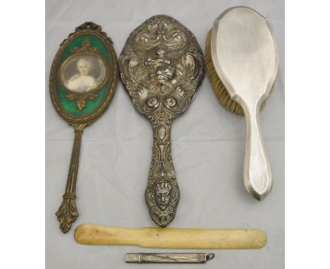 An embossed silver backed dressing table hand mirror decorated with cupid and psyche, a silver backed dressing table mirror w