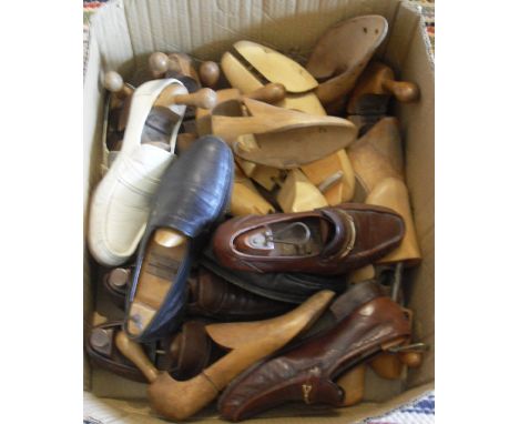 A box containing assorted wooden shoe trees 