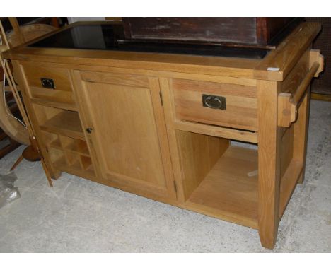 A light oak side unit buffet with black marble top above two drawers and central cupboard door 