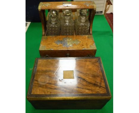 A Victorian oak and brass bound tantalus with three hobnail decanters and twin-lidded compartment opening to reveal four tot 
