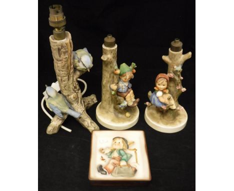 Three Goebel Hummel figural table lamp bases and a wall plaque depicting Merry Wanderer   CONDITION REPORTS  All lamps need r