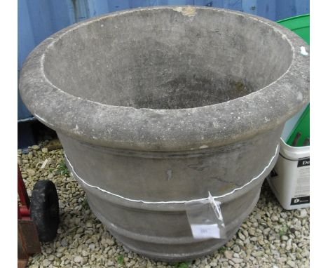 A large composite stone circular planter