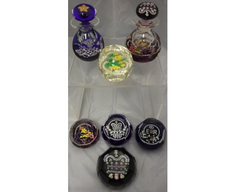 A collection of Caithness enamel decorated paperweights including 'Prestige Queen Mother' and matching scent bottle and stopp