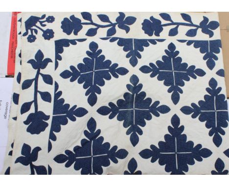 A 19th Century quilt with blue foliate style decoration on a white ground on a plain white back   CONDITION REPORTS  Some dir