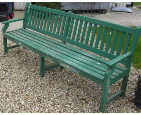 A green painted garden bench 