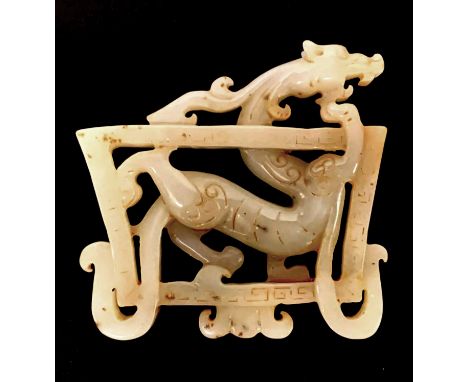 A very fine Qing Dynasty Chinese mottled mutton fat jade dragon amulet, W. 8cm.
