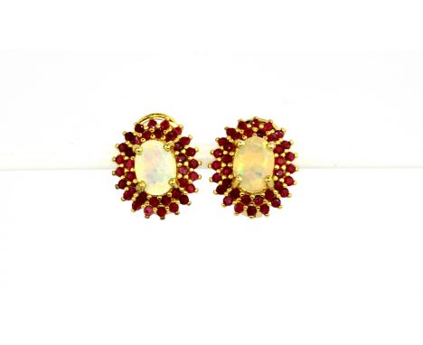 A pair of 925 silver gilt earrings set with oval cut opal and rubies, L. 1.3cm.