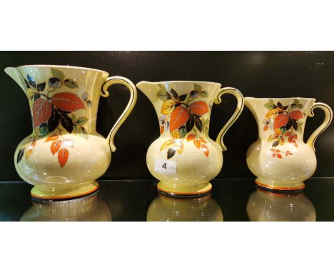 A set of three 1930's Falconware ceramic jugs, largest 20cm.