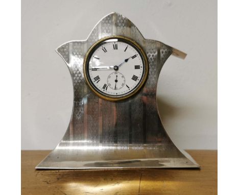 An early 20th C. hallmarked silver lady's bedside/desk clock with engine turned decoration, H. 20cm.