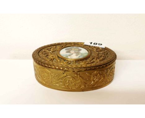 A 19th C. French brass trinket box inset with a hand painted miniature of a lady wearing a hat, W. 14cm, D. 4.5cm.