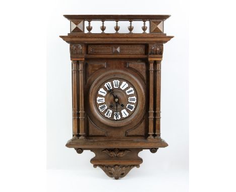 Early 20th century German oak eight day wall clock in architectural case with four reeded and turned columns, white enamel pl