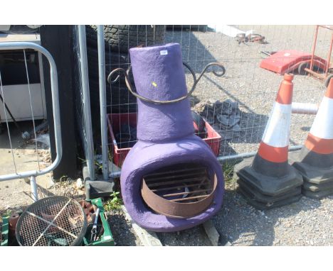 A large heavy purple painted chimenea with associated grate and lid