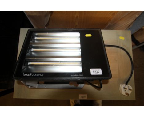 A Loxa compact LED flood light mounted to metal bracket 