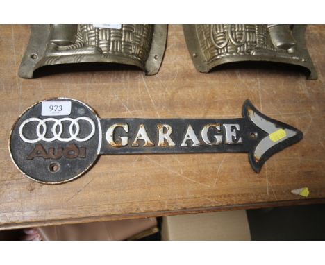 A cast iron garage arrow sign