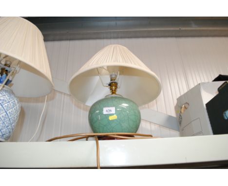 A green pottery table lamp with shade