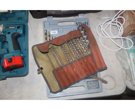 A drill bit/screwdriver bit set in fitted plastic case with various screws, rawlplugs and a canvas roll up bag containing var